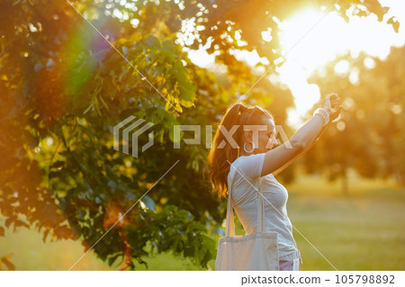 happy elegant female in white shirt outside in nature happy elegant female in white shirt outside in nature 105798892