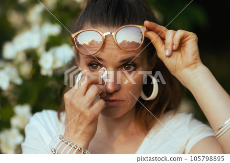 sad 40 years old woman in shirt has allergy attack 105798895