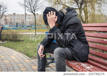 A person experiencing a crisis of drug addiction after prolonged use of drugs and medicines. A person experiencing a crisis of drug addiction after prolonged use of drugs and medicines. 105799274