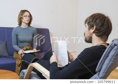 A man in the office of a psychologist is taking a test. Psychological treatment 105799611