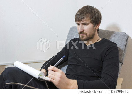 A patient sitting in the office of a psychotherapist takes a psychological test. Mental health 105799612
