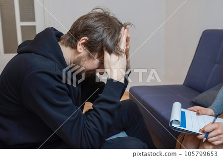 A man with his problems at a consultation with a psychotherapist. 105799653
