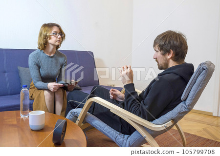 A man talks to a woman psychologist about his problems to a therapist. 105799708