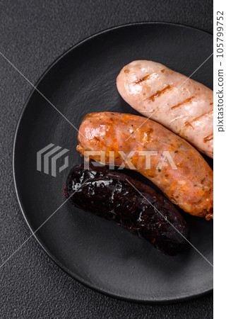 Delicious juicy sausages of several varieties grilled with salt, spices and herbs 105799752