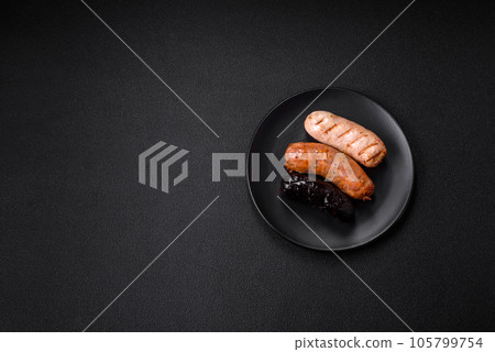Delicious juicy sausages of several varieties grilled with salt, spices and herbs Delicious juicy sausages of several varieties grilled with salt, spices and herbs 105799754