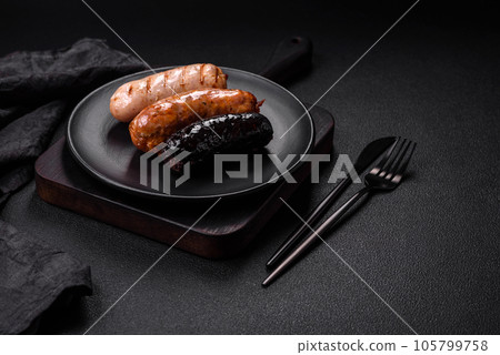 Delicious juicy sausages of several varieties grilled with salt, spices and herbs 105799758