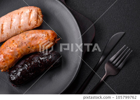 Delicious juicy sausages of several varieties grilled with salt, spices and herbs 105799762