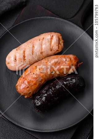 Delicious juicy sausages of several varieties grilled with salt, spices and herbs 105799763