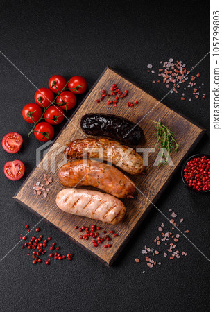 Delicious juicy sausages of several varieties grilled with salt, spices and herbs 105799803