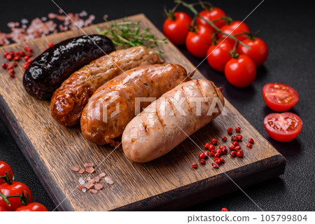Delicious juicy sausages of several varieties grilled with salt, spices and herbs 105799804