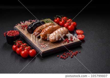 Delicious juicy sausages of several varieties grilled with salt, spices and herbs 105799807