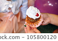 close-up, mom unwraps a festive little cupcake for her little daughter, treats her. birthday cake 105800120