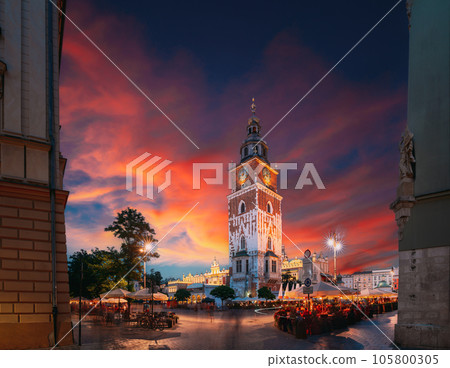 Krakow, Poland. Famous Landmark On Old Town Square In Summer Evening. Old Town Hall Tower In Night Lighting. UNESCO World Heritage Site. Krakow, Poland. Famous Landmark On Old Town Square In Summer Evening. Old Town Hall Tower In Night Lighting. UNESCO World Heritage Site. 105800305