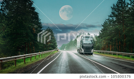 Truck Tractor Unit, Prime Mover, Traction Unit In Motion On Road, Freeway. Asphalt Motorway Highway Against Background Of Forest Landscape. Business Transportation And Trucking Industry 105800376