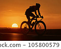 Traveler cyclist silhouette on sunset background. 105800579