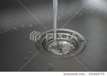 water pouring from a faucet tap slow motion  105800770