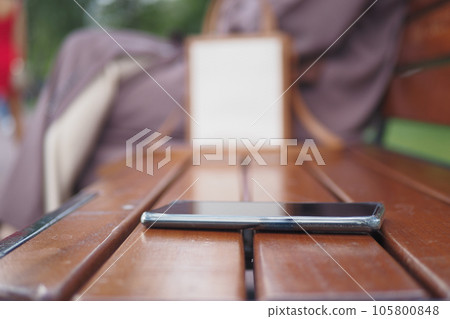 forget smartphone on a park bench, lost smart phone forget smartphone on a park bench, lost smart phone 105800848