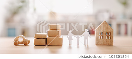 Figurines of family, house, carton boxes and car standing on the table indoors. Figurines of family, house, carton boxes and car standing on the table indoors. 105801264