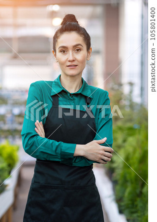 Young woman works in flower plants department in DIY store Young woman works in flower plants department in DIY store 105801400