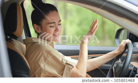 Happy looking businesswoman signs favourite song in car Happy looking businesswoman signs favourite song in car 105801468