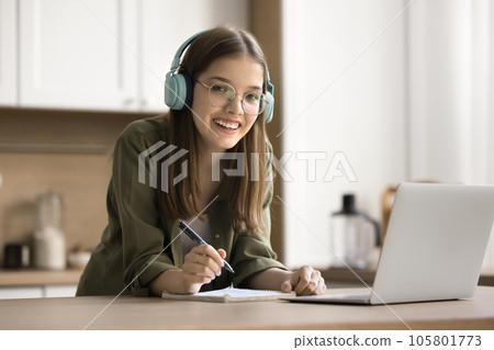 Cheerful pretty teenager school student girl wearing earphones and eyeglasses Cheerful pretty teenager school student girl wearing earphones and eyeglasses 105801773
