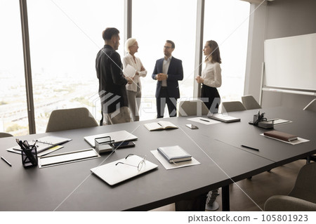 Business team of four discussing project in office conference room Business team of four discussing project in office conference room 105801923