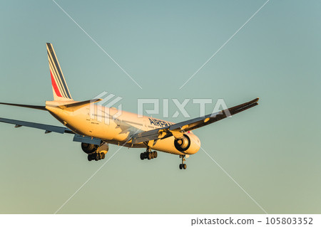 [Back view of an Air France plane landing from the sky above Jonanjima Seaside Park at sunset] 105803352