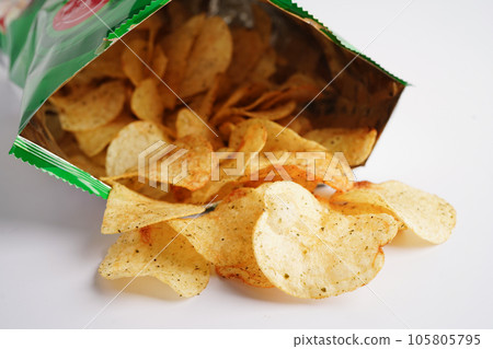 Potato chips in open bag, delicious BBQ seasoning spicy for crips, thin slice deep fried snack fast food in open bag. 105805795
