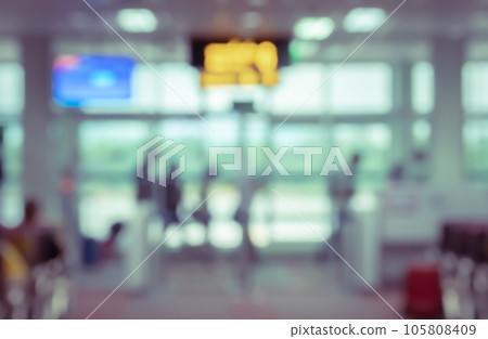 Abstract blurred background of airport terminal interior with travelers walking. 105808409