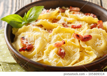 Girasoli sunflower shaped pasta with cheese, basil and bacon on plate. Horizontal Girasoli sunflower shaped pasta with cheese, basil and bacon on plate. Horizontal 105809314