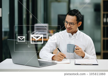 Asian man hands using Laptop, tablet typing on keyboard and surfing the internet with email icon, email marketing concept, send e-mail or newsletter, online working internet network technology. Asian man hands using Laptop, tablet typing on keyboard and surfing the internet with email icon, email marketing concept, send e-mail or newsletter, online working internet network technology. 105811860