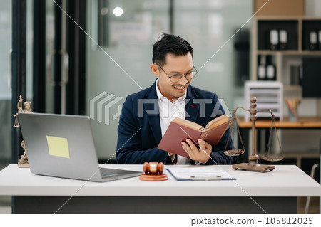 Man lawyer reading legal book with gavel on table in office. justice and law ,attorney concept... Man lawyer reading legal book with gavel on table in office. justice and law ,attorney concept... 105812025