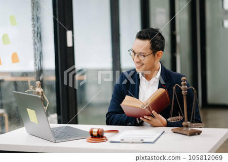 Man lawyer reading legal book with gavel on table in office. justice and law ,attorney concept... 105812069