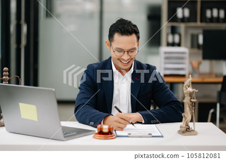 justice and law concept .Asian Male judge in a courtroom on table and Counselor working in modern office.. justice and law concept .Asian Male judge in a courtroom on table and Counselor working in modern office.. 105812081