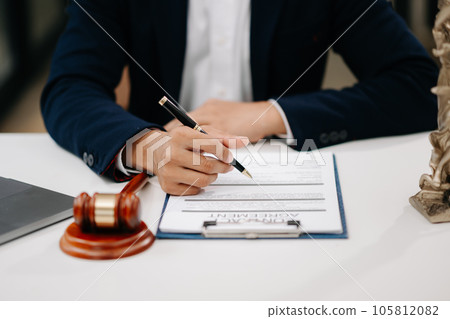 justice and law concept.Male judge in a courtroom on wooden table and Counselor or Male lawyer working in office. . justice and law concept.Male judge in a courtroom on wooden table and Counselor or Male lawyer working in office. . 105812082
