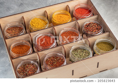 A set of spices on a light background in a glass bowl. Enhancement of taste. 105815643