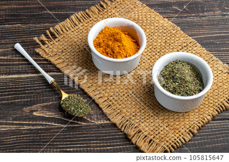 A set of spices on a light background in a glass bowl. Enhancement of taste. 105815647