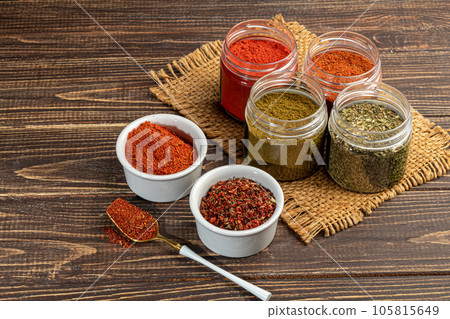 A set of spices on a light background in a glass bowl. Enhancement of taste. 105815649