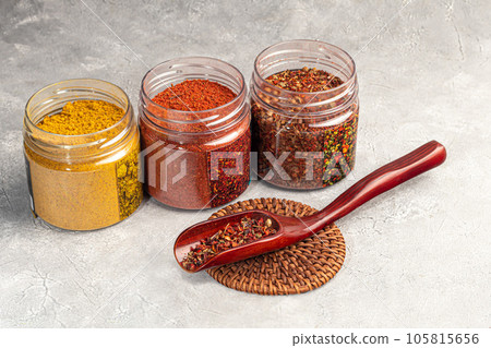 A set of spices on a light background in a glass bowl. Enhancement of taste. 105815656