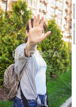 Woman showing gesture stop. Warning gesture. Domestic abuse concept. Girl reject concept. Woman rights. Social bully. Bad relations. Protection gesture. Palm before face. Body language. Victim pose. Woman showing gesture stop. Warning gesture. Domestic abuse concept. Girl reject concept. Woman rights. Social bully. Bad relations. Protection gesture. Palm before face. Body language. Victim pose. 105816056