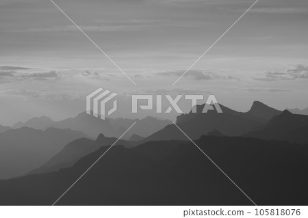Monochrome image of mountain ranges in the Bernese Oberland seen from Niesen Kulm. Monochrome image of mountain ranges in the Bernese Oberland seen from Niesen Kulm. 105818076
