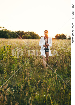 Portrait of woman in golden sunset light in outdoor meadow. Springtime and summer lifestyle. Wellbeing and zen like meditation activity in outdoor. Loving life 105818465
