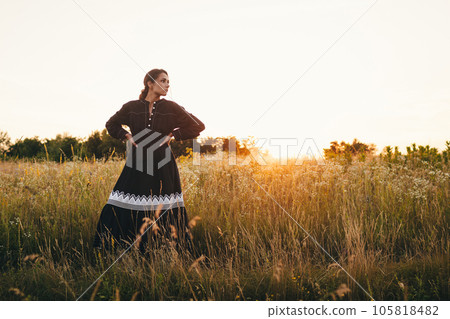 Portrait of woman in golden sunset light in outdoor meadow. Springtime and summer lifestyle. Wellbeing and zen like meditation activity in outdoor. Loving life 105818482