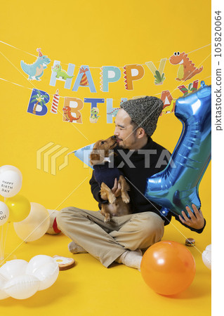 Man celebrating his dog's birthday Man celebrating his dog's birthday 105820064