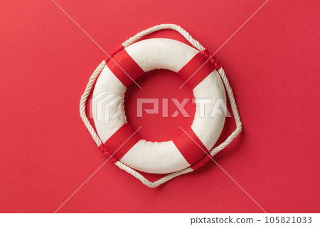 Lifebuoy on a red background, top view Lifebuoy on a red background, top view 105821033