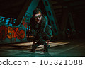 Young cool man break dancer posing on urban bridge at night 105821088