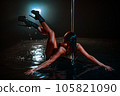 Young woman pole dancer posing in water 105821090