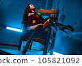 Young slim asian woman bdsm style portrait in chair 105821092