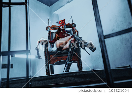 Young slim asian woman bdsm style portrait in chair 105821094