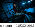 Young asian woman sitting in cage with chains bdsm style portrait 105821098